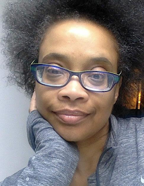 A headshot selfie of Carol Bash resting her chin in her hand.