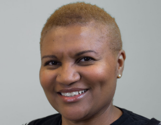 A headshot of Lisa Osborne against a neutral grey background.