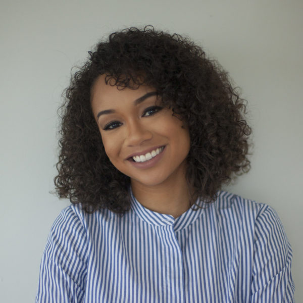 A headshot of Deniese Davis against a neutral grey background.
