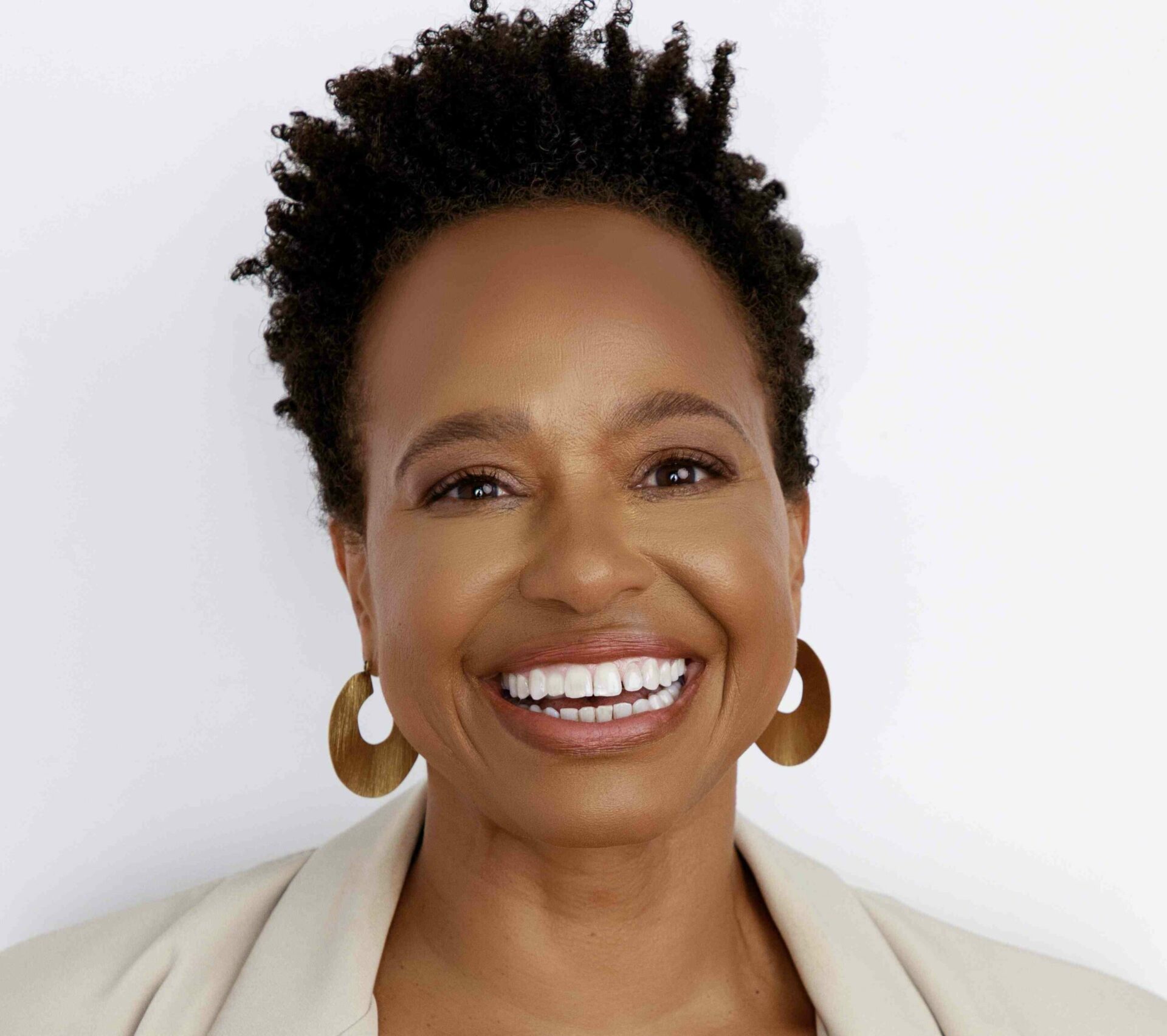 A headshot of Denise Greene against a neutral white background.